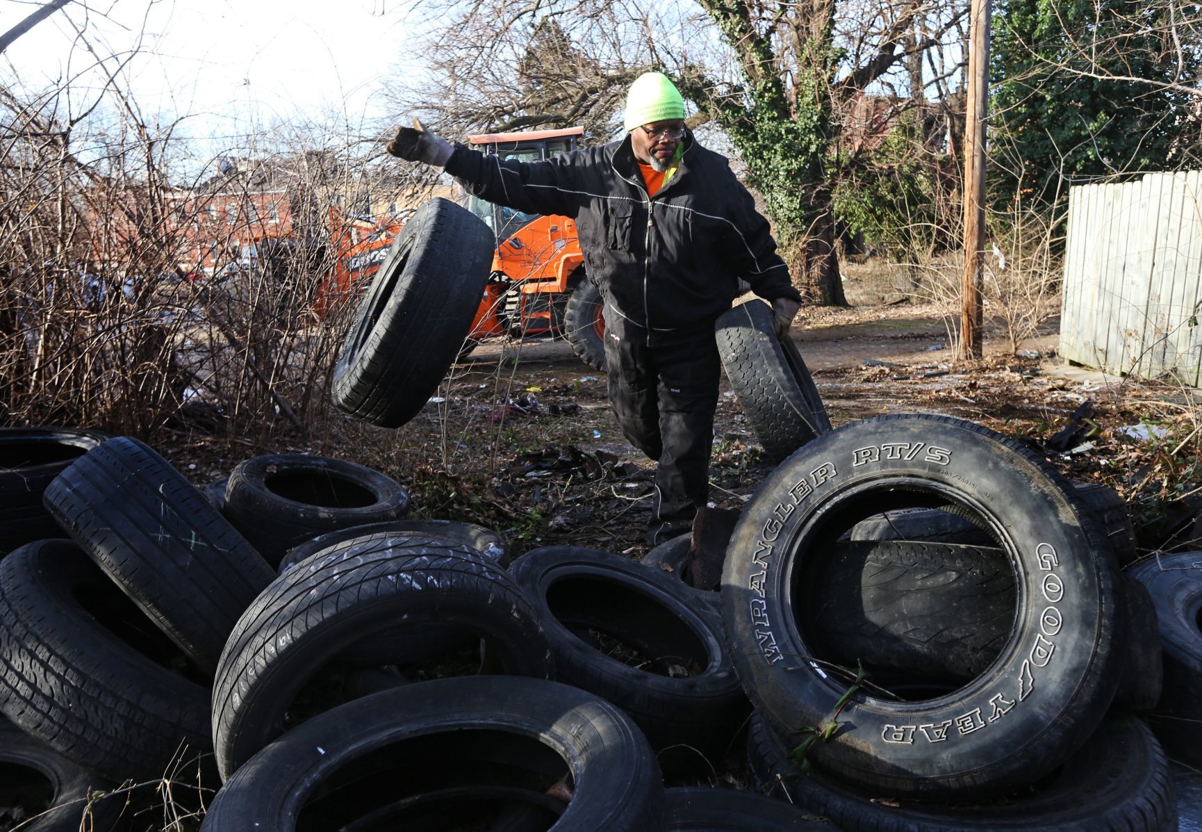Christopher Smith removes illegally dumped tires